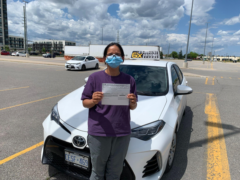 close-up-view-driving-instructor-holding-checklist-while-background