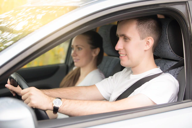 close-up-view-driving-instructor-holding-checklist-while-background